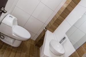 a bathroom with a white toilet and a sink at hotel orkkowasi colca in Coporaque