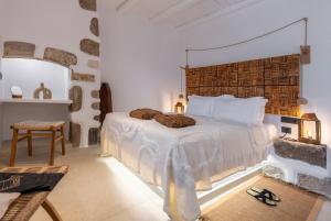 a bedroom with a large bed with a wooden headboard at stema suite 1 in Tripiti