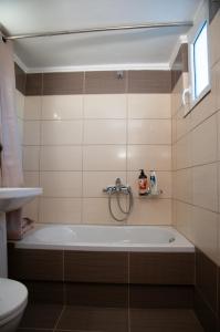 a bathroom with a bath tub and a toilet at GLIPTIS Apartments in Chios +123 photos