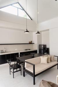 a living room with a couch and a table at Villa IKIN in Lovina