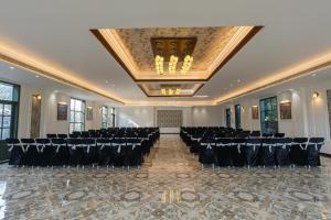 een balzaal met rijen stoelen en een plafond bij TRIDEUS THE WILD FRASER Corbett in Rāmnagar