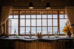 a bathroom with two sinks and a large window at Virunga Lodge in Nkumba