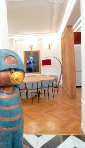 a statue of a person wearing a helmet in a room with a table at New! Apartment Luxury Passy-Kennedy in front of Eiffel Tower in Paris
