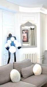 a living room with a couch and a mirror at New! Apartment Luxury Passy-Kennedy in front of Eiffel Tower in Paris