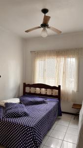 ein Schlafzimmer mit Bett und Deckenventilator in der Unterkunft Casa ampla no centro Barra Velha in Barra Velha