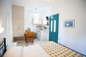 a room with a bed and a kitchen with a door at Bella Vista in Nydri