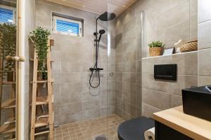a bathroom with a shower with a ladder at Luxury Apartment By Lapland Host in Rovaniemi +12 photos