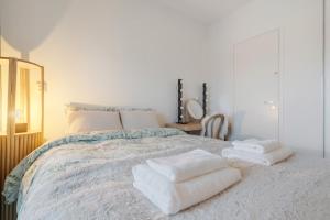 a bedroom with a bed with towels on it at Luxury Apartment By Lapland Host in Rovaniemi