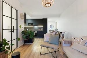 a living room with a couch and a chair at Luxury Apartment By Lapland Host in Rovaniemi