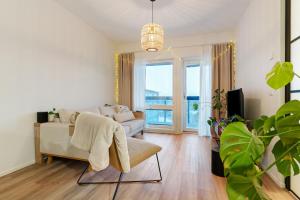 a living room with a couch and a chair at Luxury Apartment By Lapland Host in Rovaniemi