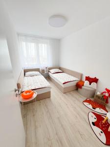 een kamer met twee bedden en een tafel erin bij A2 Severna Apartment, near City Center and High Tatras in Poprad +22 foto's