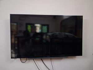 a flat screen tv hanging on a wall at MSVNATIVE HOME Stay Near Airport in Chennai