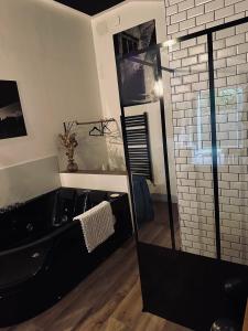bagno con vasca nera e doccia in vetro di Apt 35 m2 Baignoire Balnéo terrasse privée a Amfreville-la-Mi-Voie Altre 7 foto