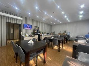 a dining room with tables and chairs and a tv at Boutique Hotel's Sosnowiec in Sosnowiec