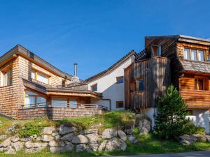 a large wooden house with a stone wall at Chalet moderne 16 pers. au cœur d'Avoriaz avec sauna - FR-1-314-95 in Avoriaz