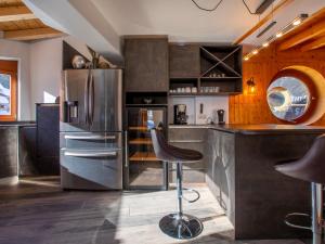 a kitchen with a stainless steel refrigerator and a counter at Chalet d'exception à Avoriaz pour 12 pers, 6 chambres, sauna et petit-déjeuner inclus - FR-1-314-97 in Avoriaz