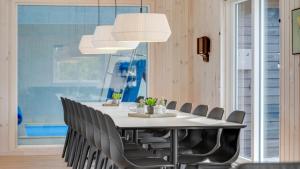 una sala da pranzo con tavolo e sedie bianchi di Villavilla #488 - Mommark, Sydjylland a Sarup