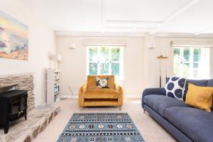 a living room with a couch and a chair at Hansel Cottage in Dartmouth