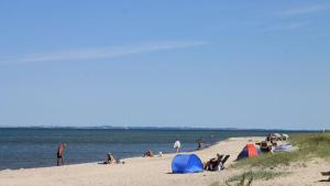 Un grupo de personas en una playa con tiendas de campaña. en Villavilla #286 - Nordals, Sydjylland, en Nordborg