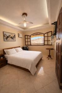 a bedroom with a large white bed with a ceiling at Casa Entre o Mar e a Lagoa in Saquarema +22 photos