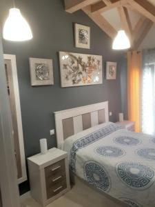 a bedroom with a bed and some pictures on the wall at Entrecuevas - Rural Accommodation in Arredondo +30 photos