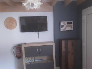 a living room with a flat screen tv on the wall at Entrecuevas - Rural Accommodation in Arredondo