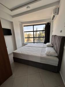 a bedroom with a large bed and a window at Tanger sun studios in Tangier