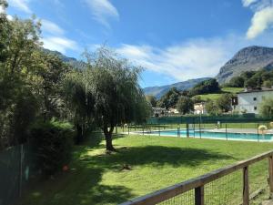 a swimming pool with a tree and a fence at Entrecuevas - Rural Accommodation in Arredondo