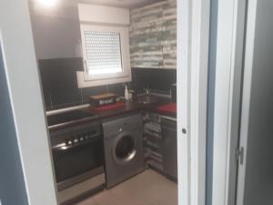 a kitchen with a washer and a washing machine at Entrecuevas - Rural Accommodation in Arredondo
