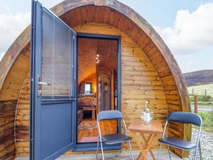 a small circular house with a table and chairs at The Pod at Greenbank in Kilbride