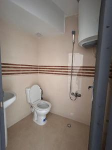 a small bathroom with a toilet and a sink at Tanger sun studios in Tangier