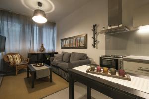 a living room with a couch and a table at Annita's Cozy Loft Volos in Volos