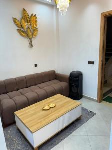 a living room with a couch and a coffee table at Dar aya in Beni Mellal