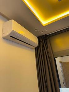 a air conditioner hanging from a ceiling in a room at Dar aya in Beni Mellal