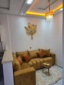 a living room with a couch and a table at Dar aya in Beni Mellal