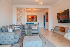 a living room with a couch and a table at Marina Agadir Grand Luxury 3 Bedroom Sea view Apartment-familial in Agadir