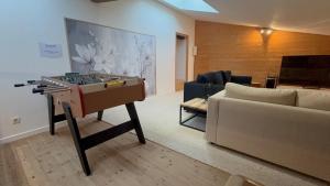 a living room with a piano and a couch at L Experience Bressane 2 in Saint-Trivier-de-Courtes