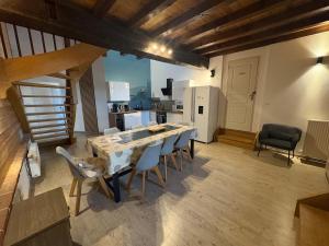 a kitchen and dining room with a table and chairs at L Experience Bressane 2 in Saint-Trivier-de-Courtes +32 photos