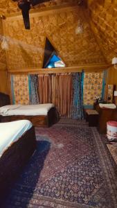 a bedroom with two beds in a room at Heritage Houseboat - Almost Heaven in Srinagar +2 photos