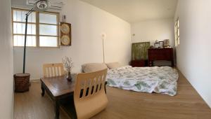 Postel nebo postele na pokoji v ubytování 沐時光民宿