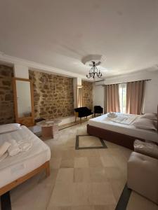 a large room with two beds and a chair at Appartement Domaine Du Soleil Hammamet 