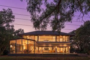 a house with large glass windows at SaffronStays La Mia Casa in Jāmb