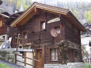 a log cabin with a sign on the side of it at wooden chalet in Betten near the Aletsch Arena in Betten
