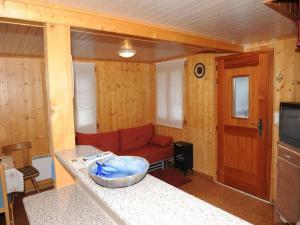 a living room with a couch and a table at wooden chalet in Betten near the Aletsch Arena in Betten +23 photos