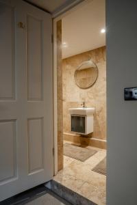a bathroom with a sink and a mirror at BATH Luxury Georgian Flat in Bath +13 photos