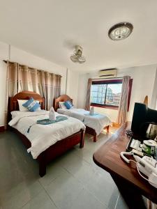 Ένα ή περισσότερα κρεβάτια σε δωμάτιο στο Walking Street Hotel Vang Vieng