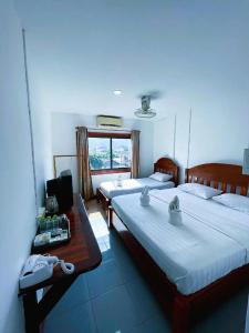 Ένα ή περισσότερα κρεβάτια σε δωμάτιο στο Walking Street Hotel Vang Vieng +3 φωτογραφίες