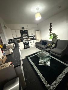 a living room with a couch and a table at Premiership Lodge in Beeston Hill
