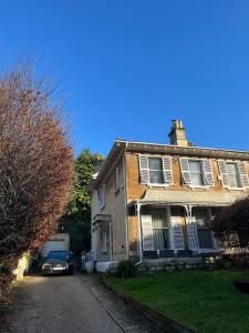 a house with a car parked in front of it at BATH Luxury Georgian Flat in Bath
