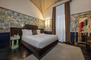 a bedroom with a bed with colorful wallpaper at V Collection Condotti in Rome +32 photos